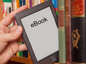 hand taking off of the shelf an eBook reader
