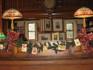 Christmas Lights, cards, and Garland in the Nevins Library reading room.