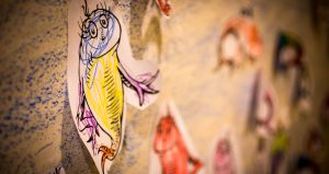 A picture of cartoon fish on a wall.