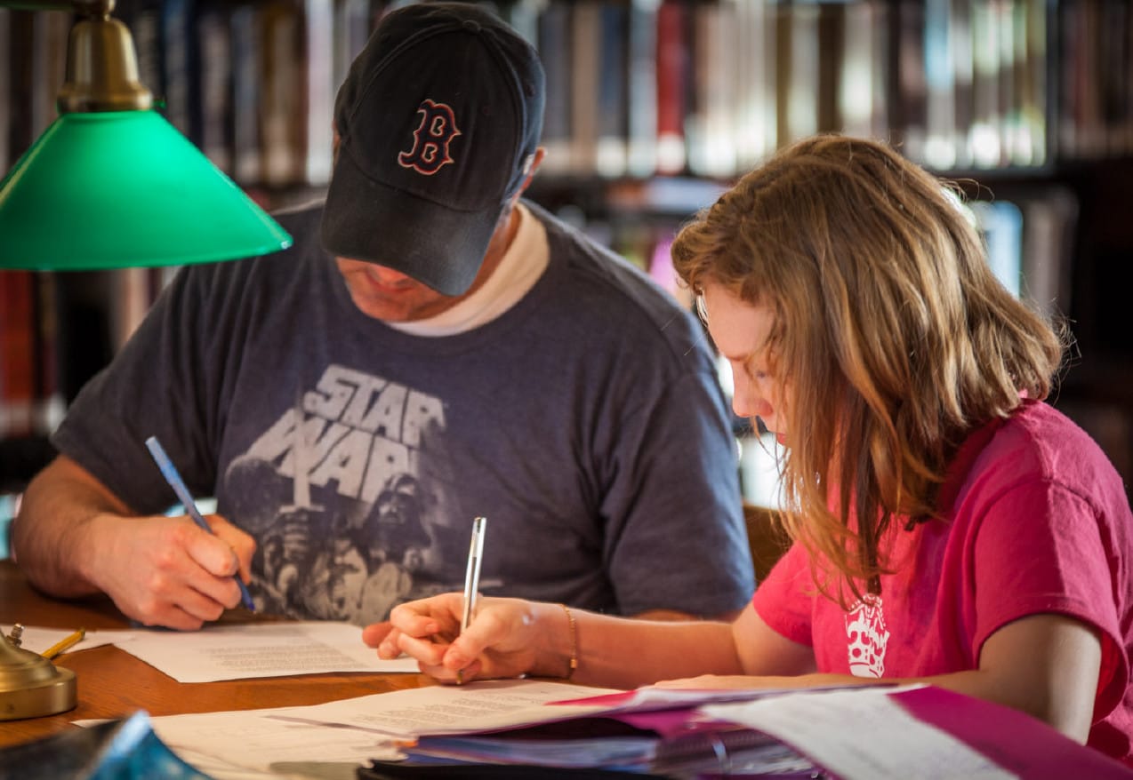 A picture of a father and daughter working.