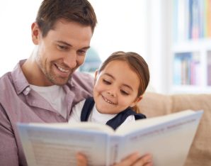 a girl and her dad reading.