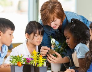 A picture of some kids surrounding some plants.
