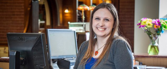 A picture of a librarian smiling.