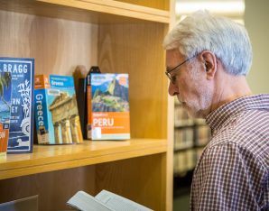 A picture of an old man reading.