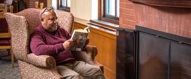 A picture of a guy reading.