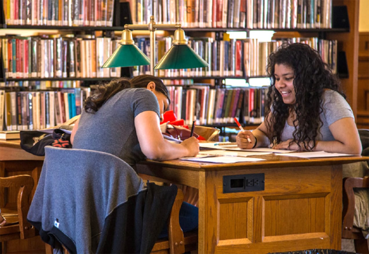 A picture of two girls at a desk.