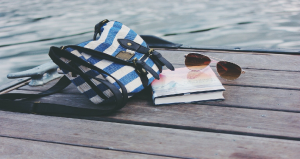 Glasses, Book, and Handbag on the edge of a dock