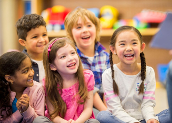 Kids laughing at story being read to them