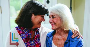 two older women smiling at one another