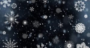 Snowflakes falling on a dark blue/black background