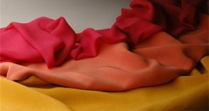 A red, yellow, and orange scarf on a table