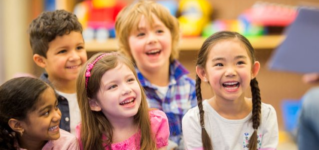 Group of young children laughing and smling