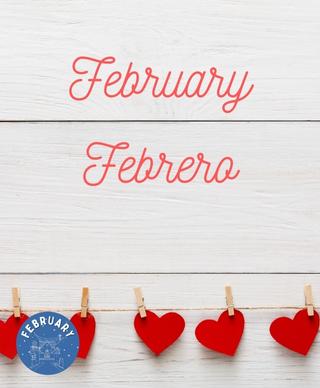 An off white wall with the words February and Febrero on it and cut out hearts put up with clothespins in a row under the words
