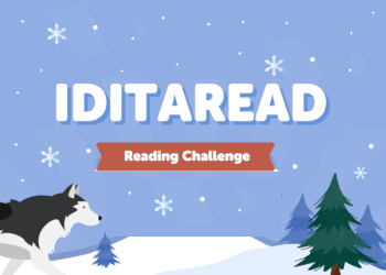 A black and white sled dog and a pine tree on a blue snowy sky background and snowy hill with the words Iditaread Reading Challenge in the middle