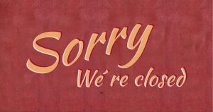 Brick red with the words sorry we're closed in yellow