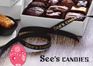 A chocolate and caramel candy on a plate on the left with a box of various chocolate candies to its right and below both a pink easter egg and the words See's Candies