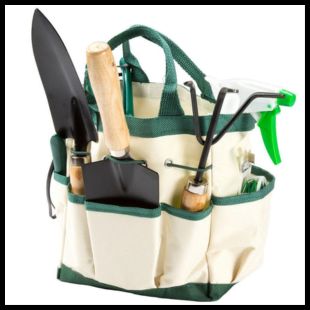 Green and beige tote bag with gardening hand tools including a spade in its pockets