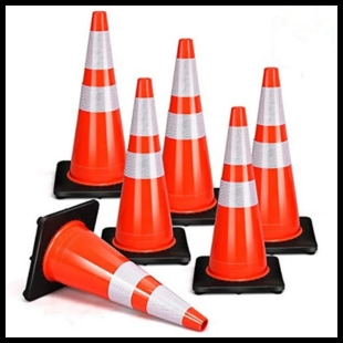 Five orange and white safety cones standing up and one safety cone on its side
