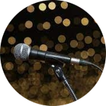 Silver and black Microphone on a background of gold circle sparkles
