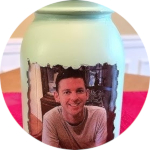 Light green painted mason jar with the picture of a light skinned man on it
