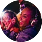 A light skinned woman and dark skinned woman dancing with headphones on