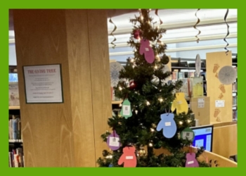 Christmas Tree with white lights, real ornaments, and paper mittens and paper bell ornaments on it