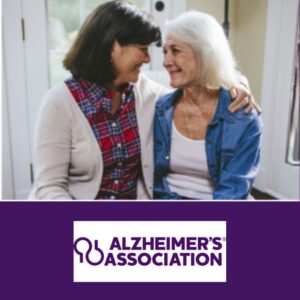 Two older women with arms around one another smiling at each other with the words Alzheimer's Association below