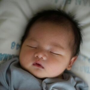Light skinned dark haired baby asleep