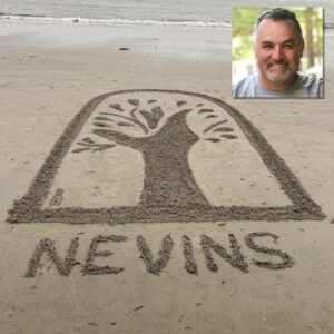 Nevins Library logo in sand with photo of light skinned man with grey hair and goatee in upper right