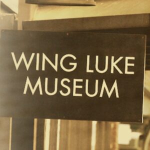 A Dark sign with white letters saying Wing Luke Museum