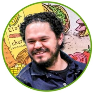 Light skinned man with dark curly hair smiling