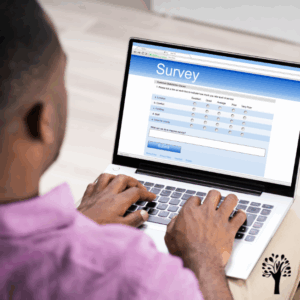 Dark skin man with laptop computer on his lap taking an online survey