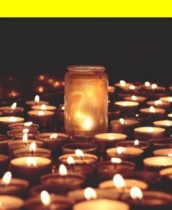Many small candles on a flat surface with a candle in a mason jar in the middle