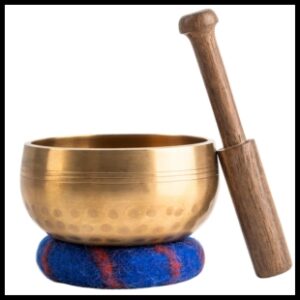 Gold tibetan singing bowl with a wooden stick