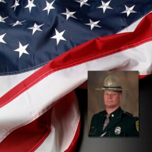 A waving American flag with the picture of a light skinned man in a brown uniform and hat overlayed on it