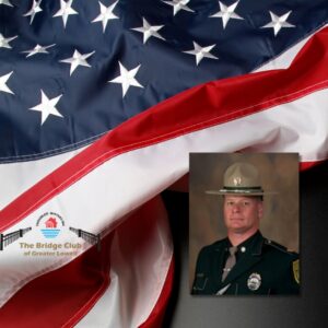 A waving American flag with the picture of a light skinned man in a brown uniform and hat overlayed on it