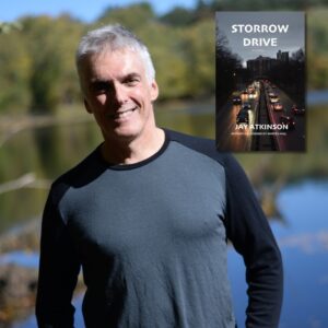 Grey haired man in a long sleeved grey t shirt