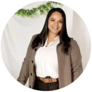 Smiling tan skinned brunette in a white shirt and blazer