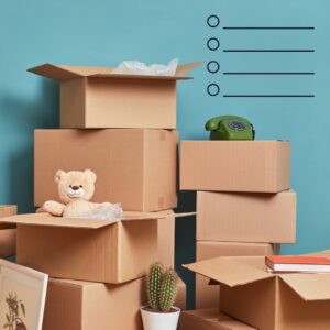 Stack of closed and open cardboard boxes with a bear and a rotary phone on it